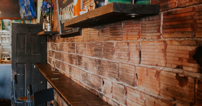 Seating area by the wall with bar stools