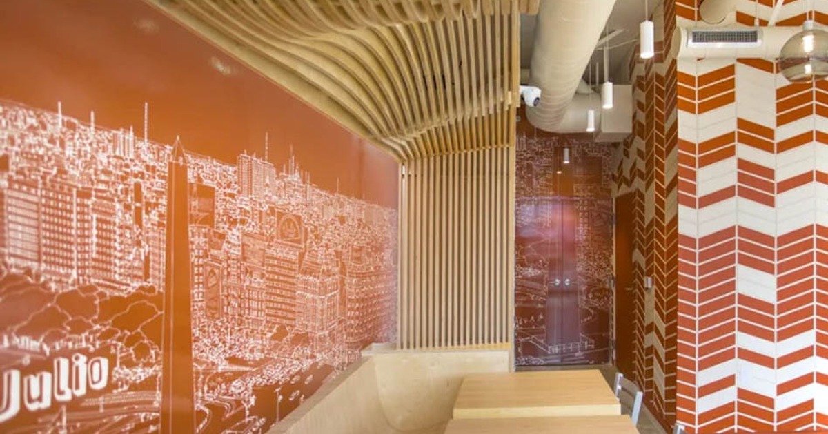 Interior featuring a distinctive curved plywood ceiling, wall mural and booth seating