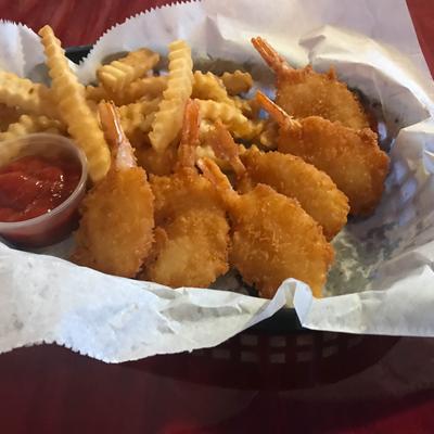 Fried shrimp, with fries, and dipping sauce.
