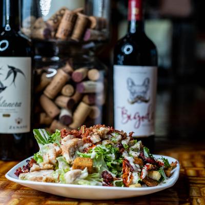 Chopped Roasted Chicken Cesar Salad served with wine
