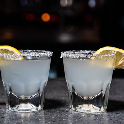 Lemon drop shots, with sugar rim and lemon slice garnish.