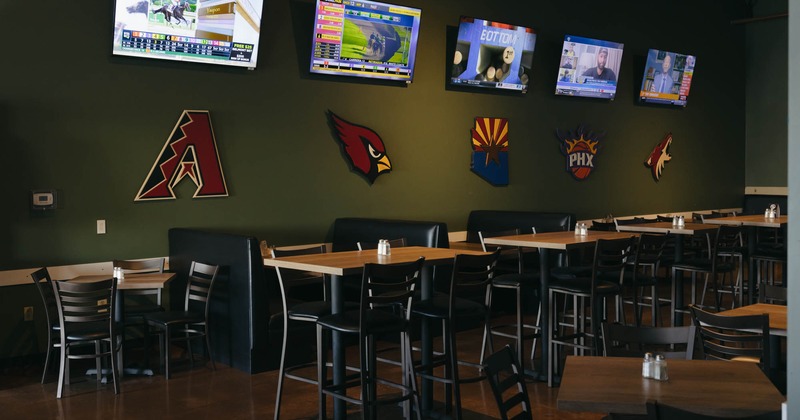 Interior seating area with chairs, tables and double booths