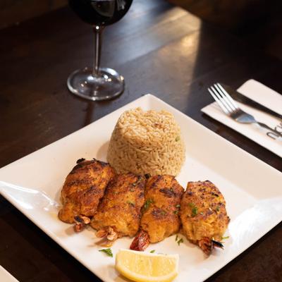 Panko shrimp and rice with lemon wedge.