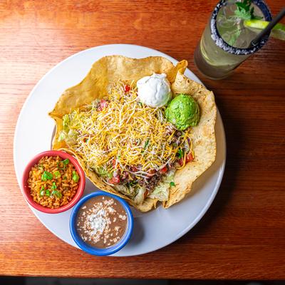 Taco salad with refried beans and rice on the side.