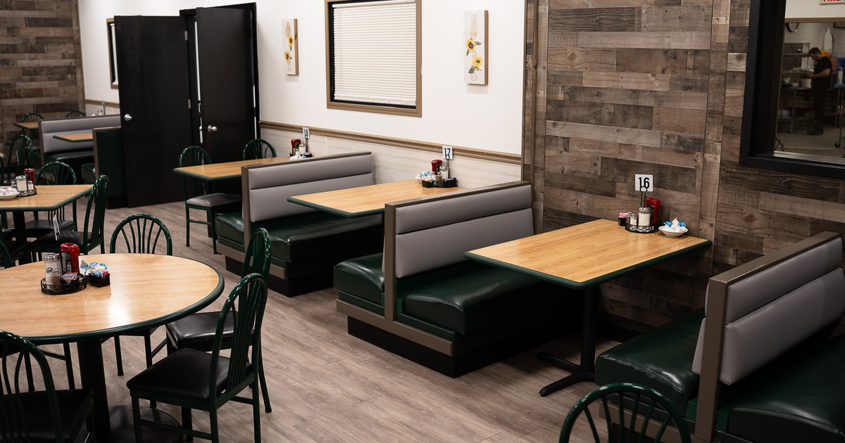 Cozy interior dining area with tables, chairs and upholstered booths