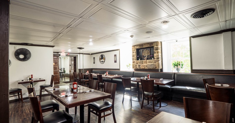 Interior dining area with chairs, tables and leather booths