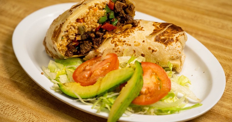 Beef burrito served with a salad