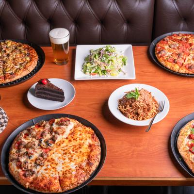 Variety of pizzas served alongside pasta, salad, dessert and drinks.
