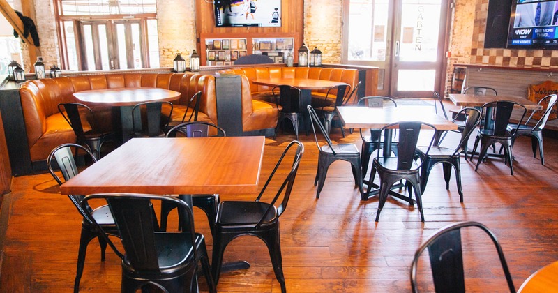 Interior, tables and chairs, seating booths, restaurant entrance in the back