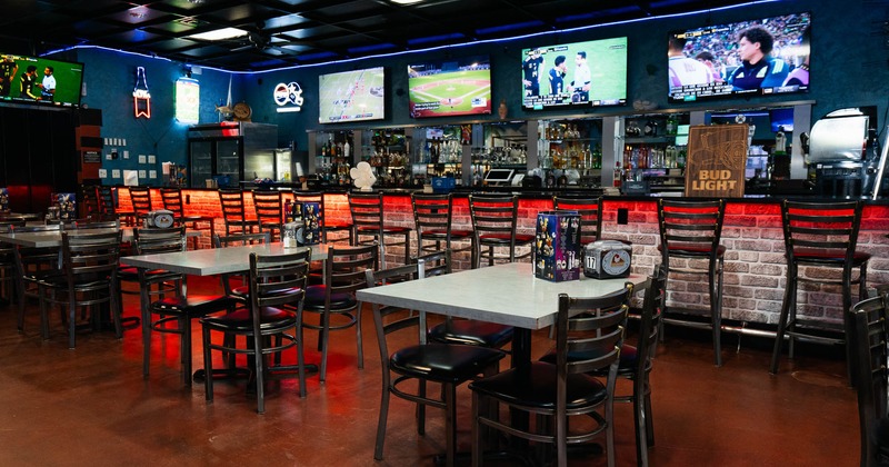 Interior, tables and chairs near bar
