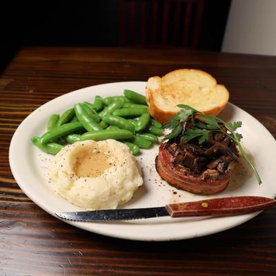 Filet Mignon, with sauteed mushrooms, garlic mashed potatoes, and sugar snap peas.