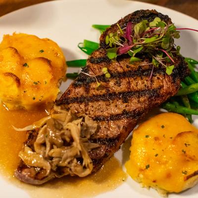 Grilled New York Strip Steak, green beans, potatoes, and mushrooms.