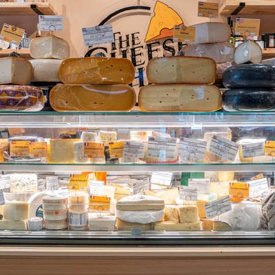 Assorted cheeses in the display case.