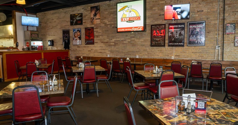 Interior, tables for four people, pictures on the wall