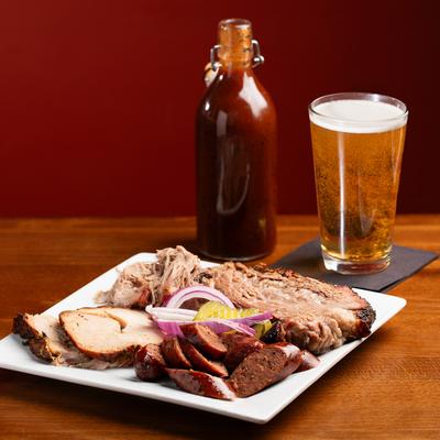 Mixed smoked meats, and a glass of beer.