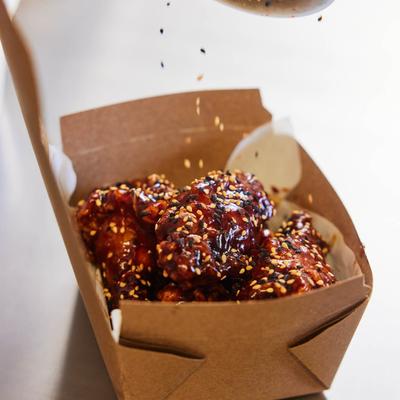 Korean fried chicken in a takeout box.