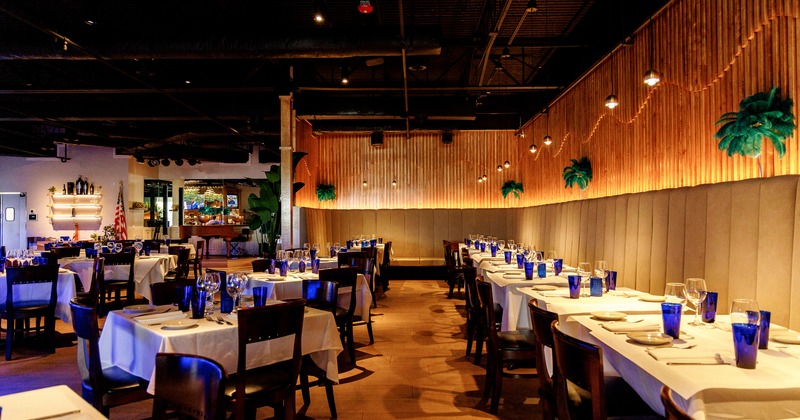 Spacious, modern, and cozy dining area with dining tables set and ready for guests