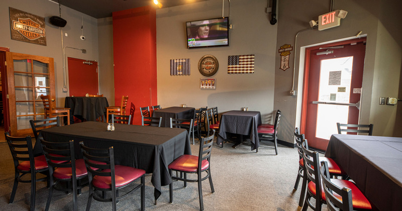 Tables ready for guests, TV on the wall