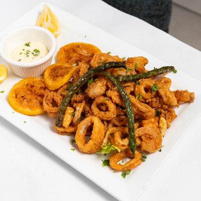 Fried calamari with dipping sauce and lemon.