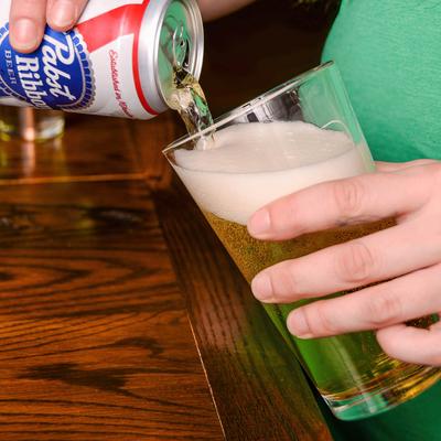 Pouring beer from a can into a glass