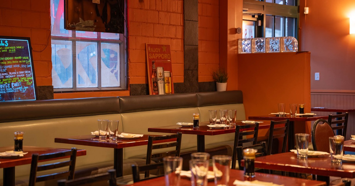Interior, tables and chairs lined up, with tableware