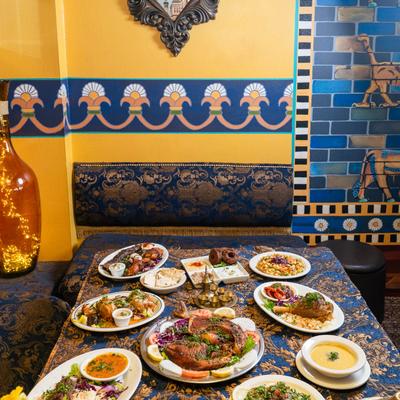 Table spread with assorted dishes, served in the restaurant setting with ornate decor.