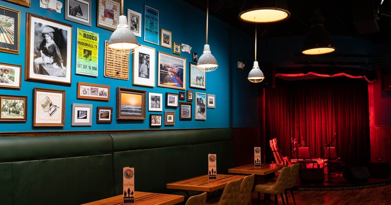 Interior, seating area beside a blue wall decorated with lots of framed pictures