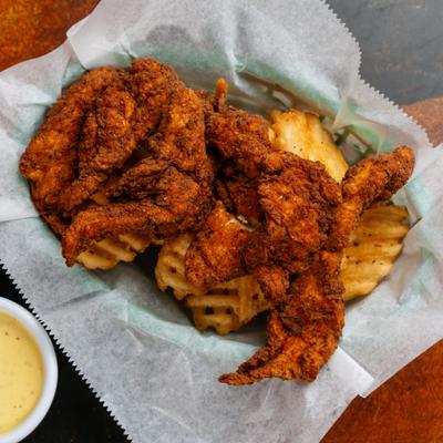 Chicken Strips served with waffle fries.