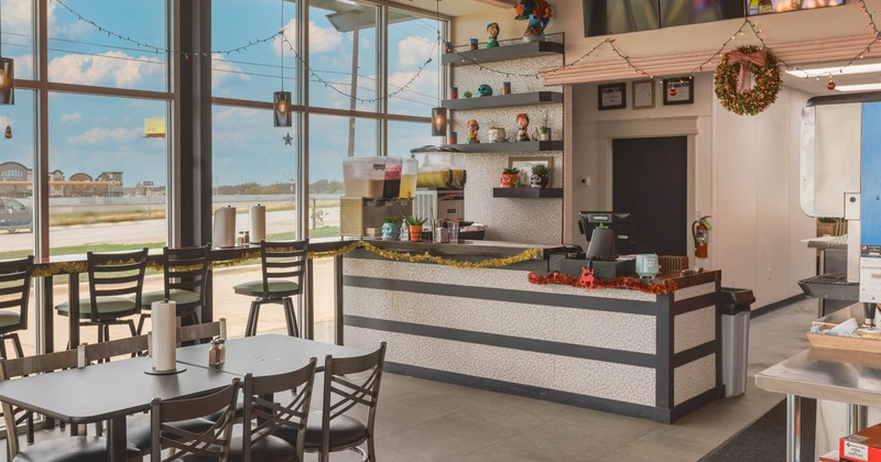 Interior, tables and chairs, bar in the background