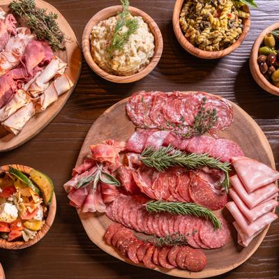 Deli meat boards and sides, top view.