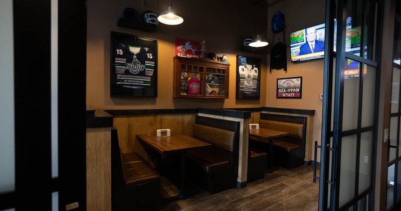 Interior, dining area, seating booths with wooden top tables, various wall decoration