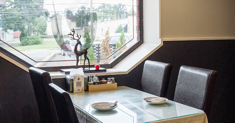 Dining table by the window set for guests