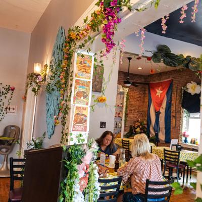 Interior with wall decorations and people siting at the table.