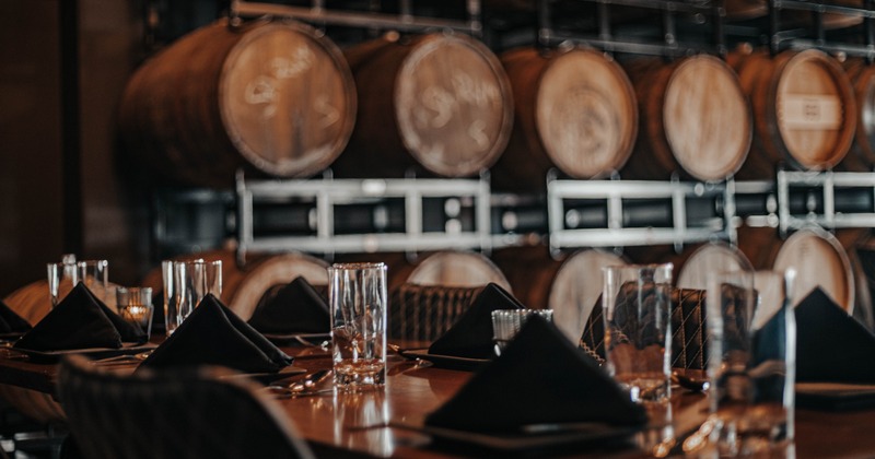 Table setting close up with blurred barrel racks in the background