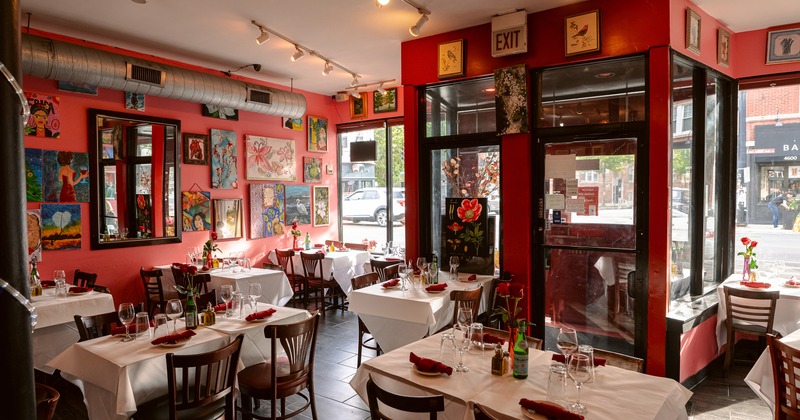 Interior of vivid and cozy dining area with set dining tables