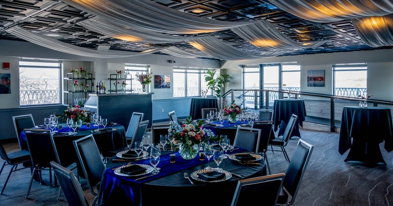 Elegant dining room - round tables, floral centerpieces and draped ceiling fabric