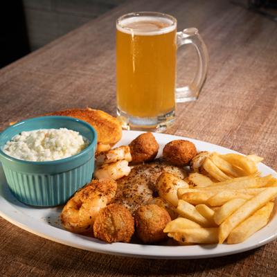Grilled fish fillet, blackened scallops, sauteed shrimp, coleslaw, and fries.