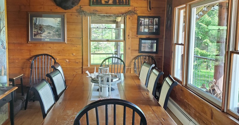 A well-furnished dining room with a wooden table and comfortable chairs for a cozy meal setting