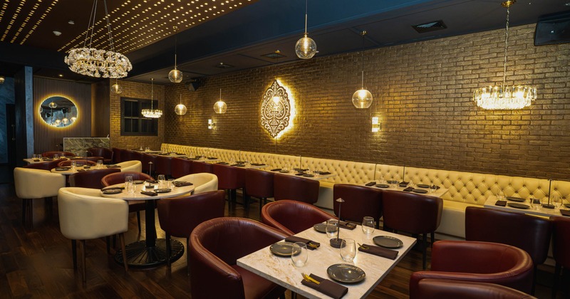Interior, spacious dining area with tables set for guests