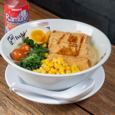 Sapporo Vegetarian Ramen topped with teriyaki tofu, corn, kale, tomato and a half egg.