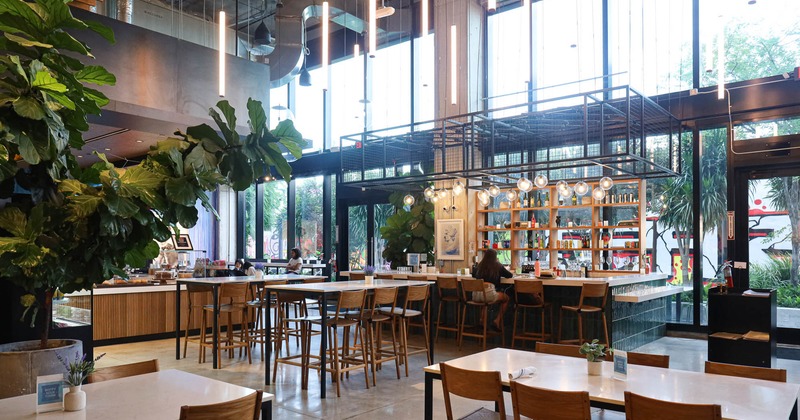 Interior, high seating area, bar with stools, large shop windows, restaurant entrance