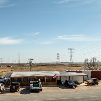 View of the restaurant building with parked trucks in front.
