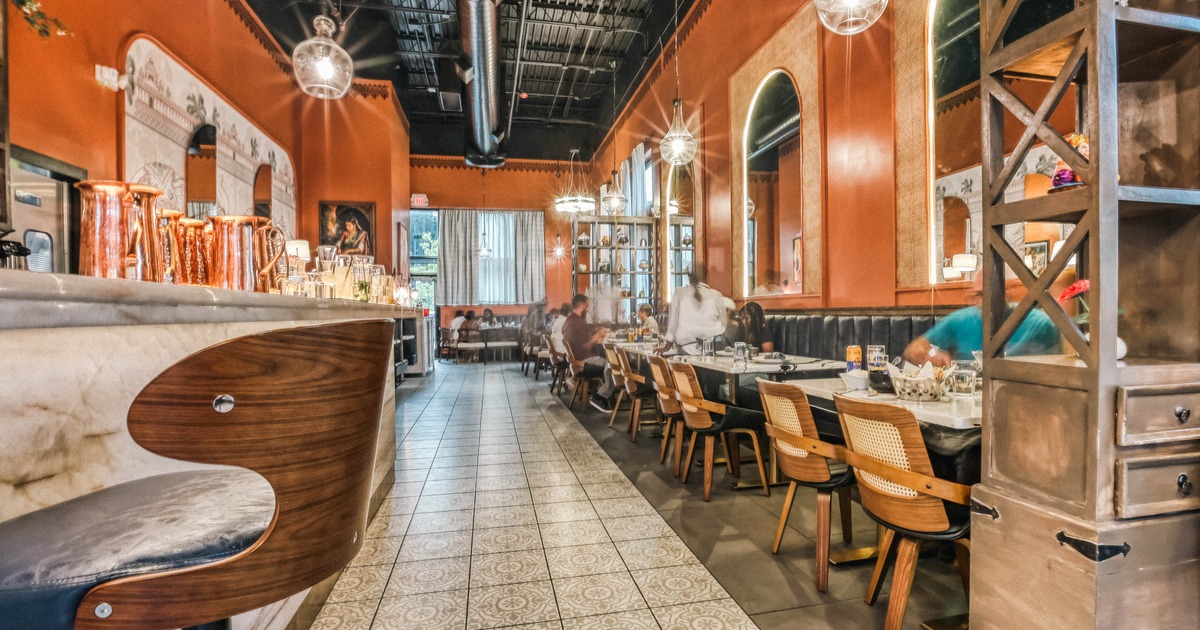 Interior, dining tables, mirrors, and patterned tile floor