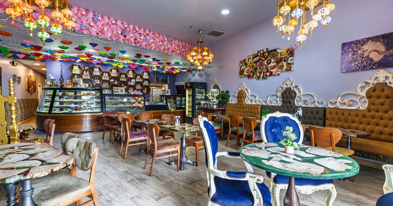 Cozy and colorful lounge seating area with vintage-style chairs and tables with decorative tabletops
