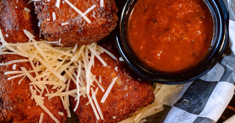 Fried Mac and Cheese squares served with marinara sauce, close-up