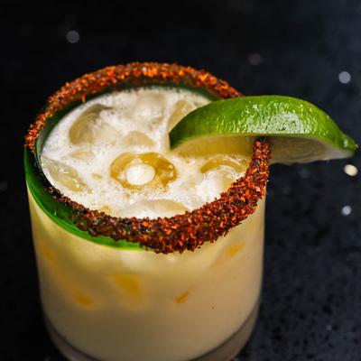 Coconut Margarita with spiced rim and lime wedge garnish.