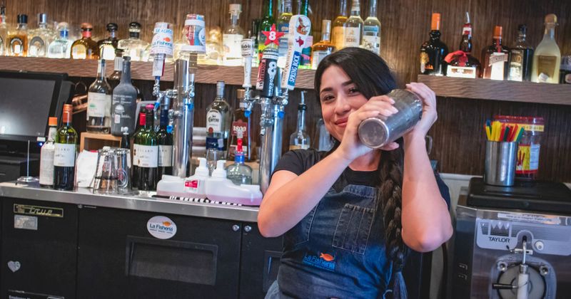 A staff member making a cocktail