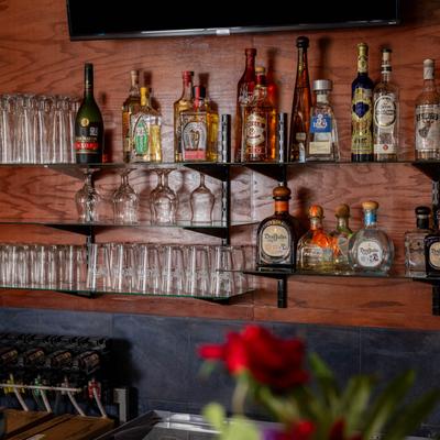 Bottles and glasses on shelves.