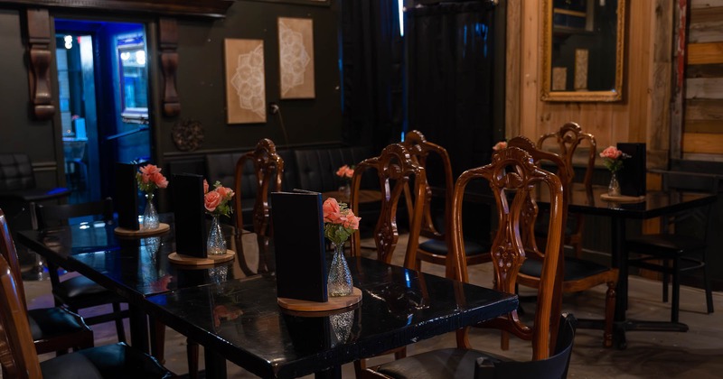 Interior, wooden chairs and black tables ready for guests
