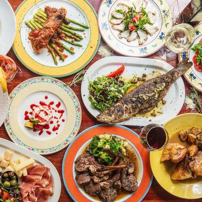 Assorted Italian dishes are served family-style on a table.